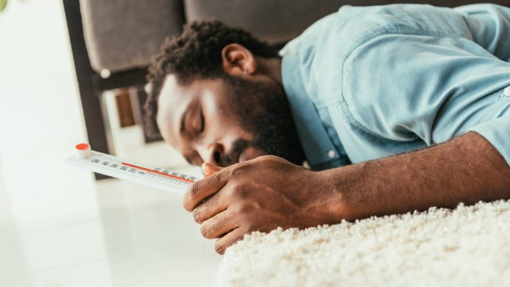 Best Time to Take Tongkat Ali: Before Bed? 2 Young African Man sleeping hot in bed because of Tongkat Ali